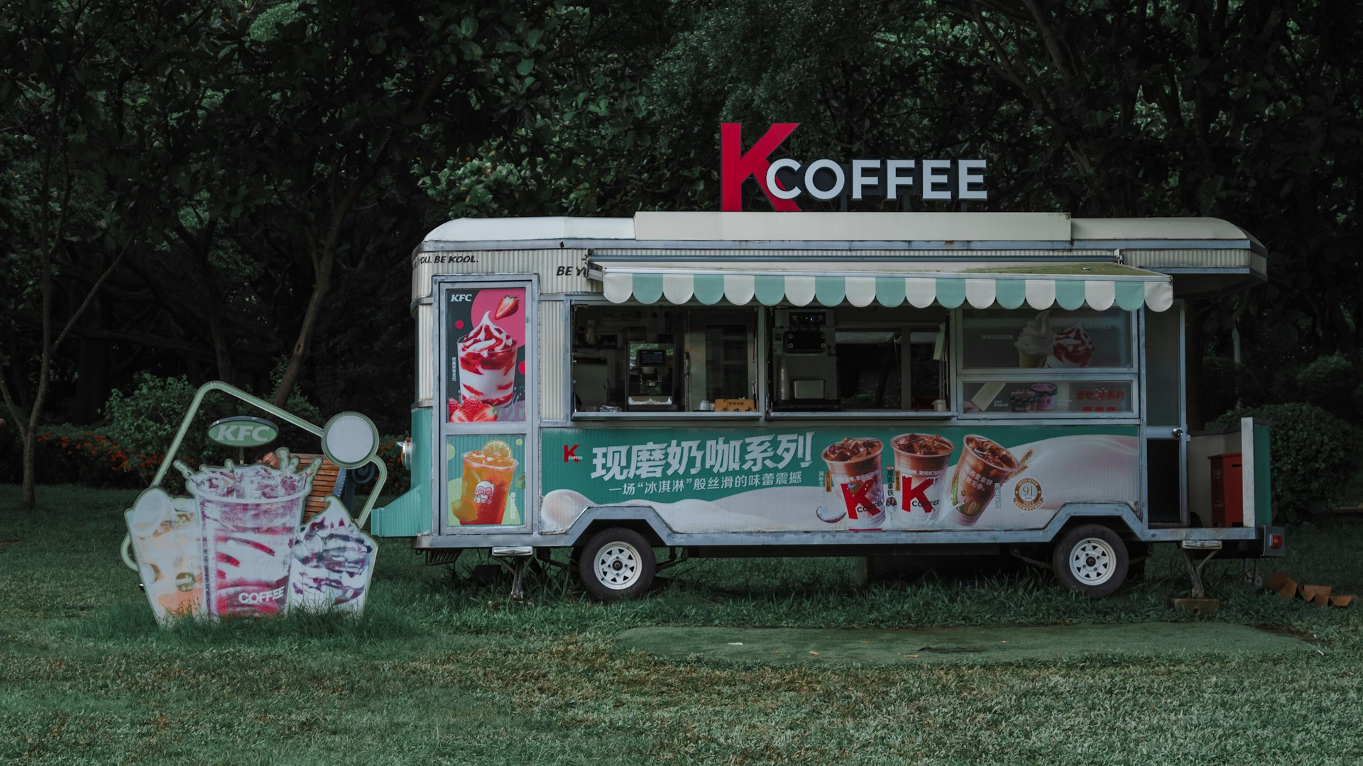 a food truck is parked in the grass